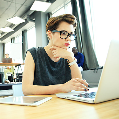 Hipster Woman use Laptop huge Loft Studio.Student Researching Process Work.Young Business Team Working Creative Startup modern Office.Analyze market stock,new strategy.Blurred,film effect.