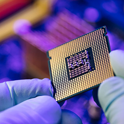 Computer support engineer installing processor. Microprocessor with clearly visible silicon core and cache chip. Installation of computer processor in the socket