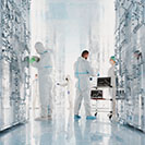 Futuristic server room with quantum computers and group of scientists