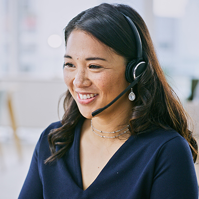 Woman, smile on computer and call center communication, customer service or e commerce support in office. Professional advisor, virtual assistant or Asian consultant for contact us and business FAQ